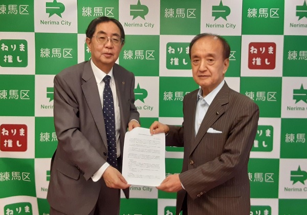 前川区長に要望を渡す石塚会長（左）